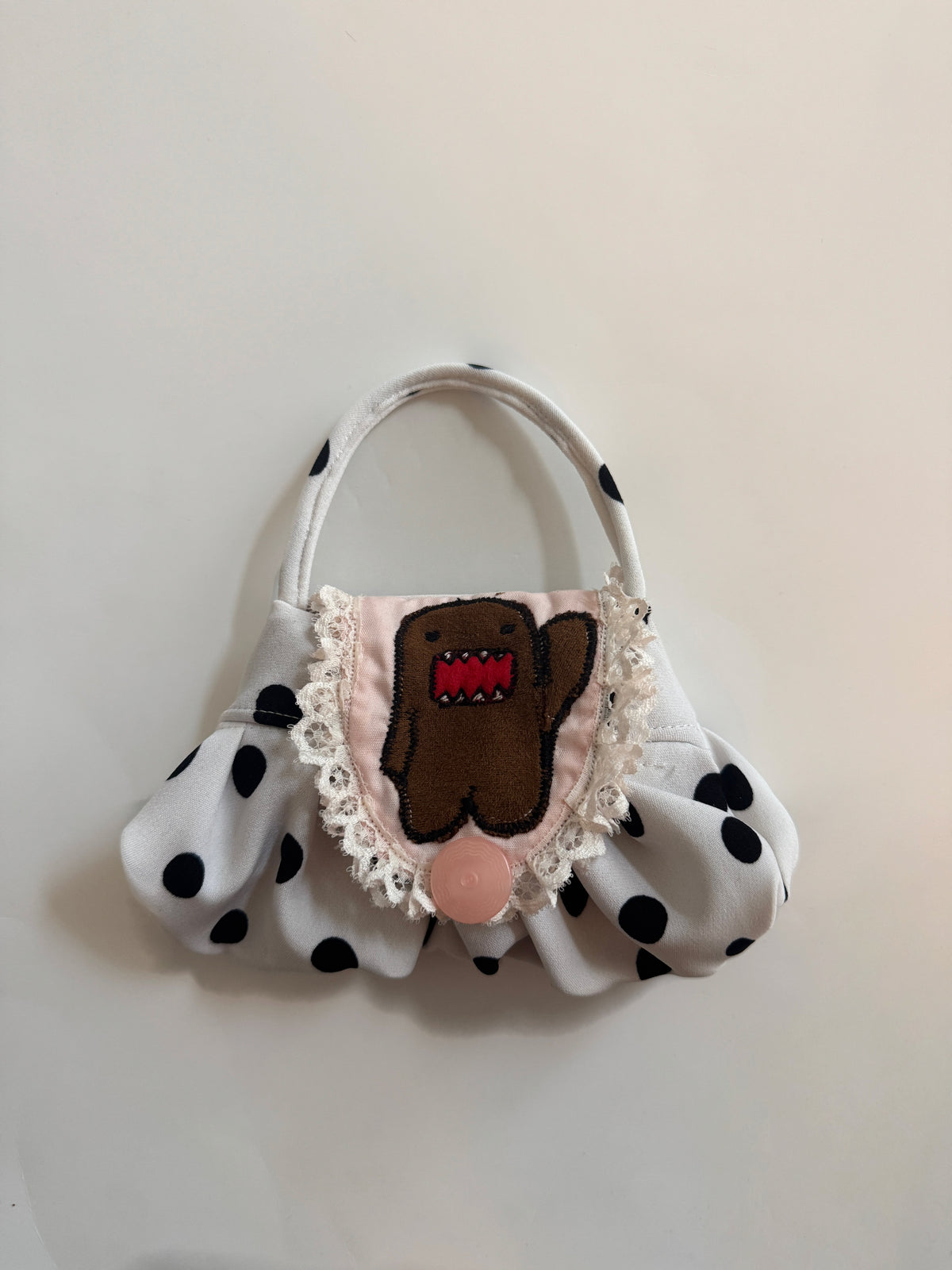 “domdom” embroidered pouch