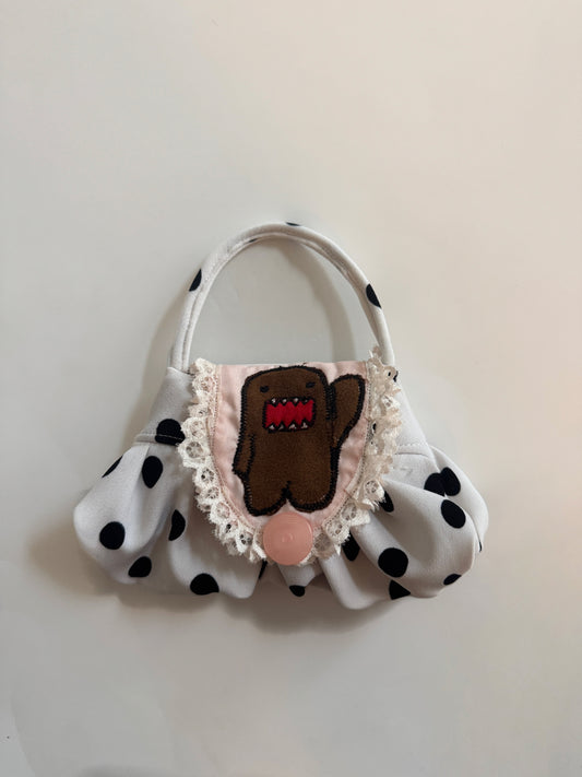 “domdom” embroidered pouch